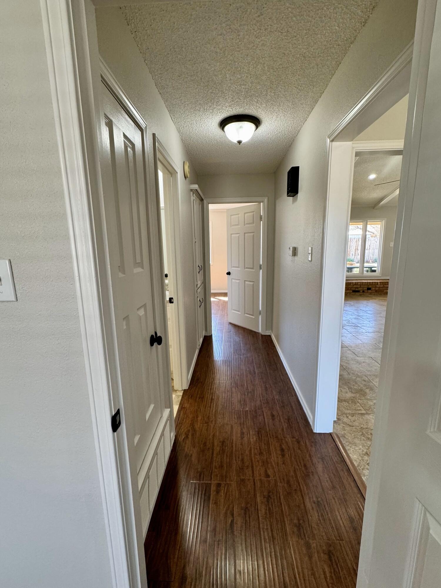 5421 94th Street Lubbock, TX 79424 - Photo 13 of 22 a view of a hallway with wooden floor
