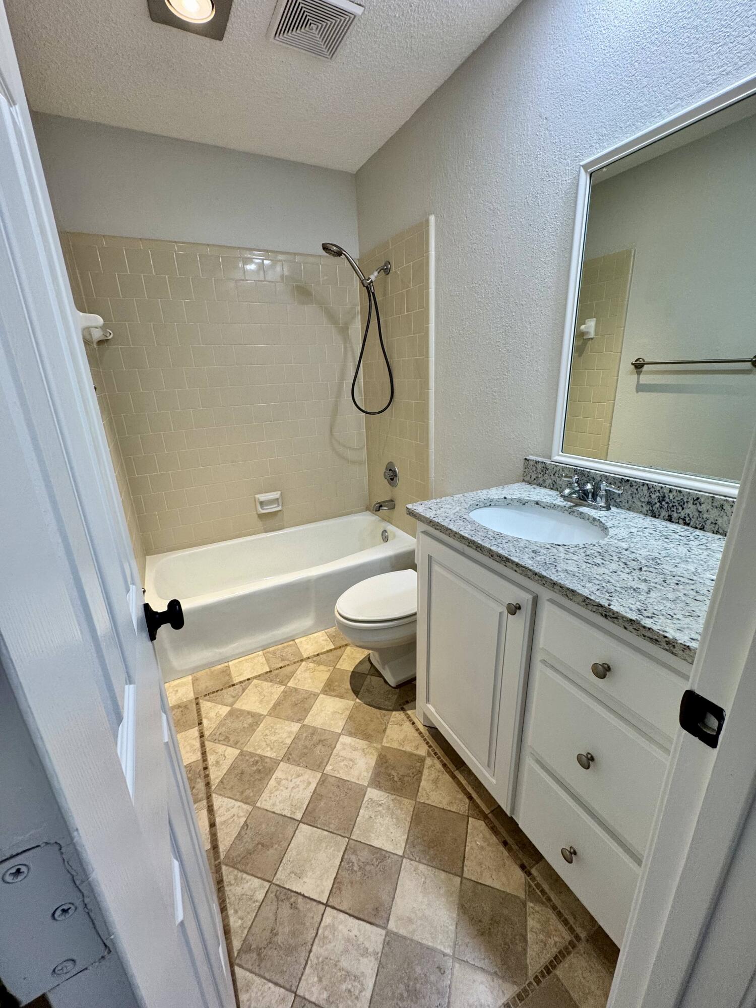 5421 94th Street Lubbock, TX 79424 - Photo 15 of 22 a bathroom with a granite countertop sink toilet and shower