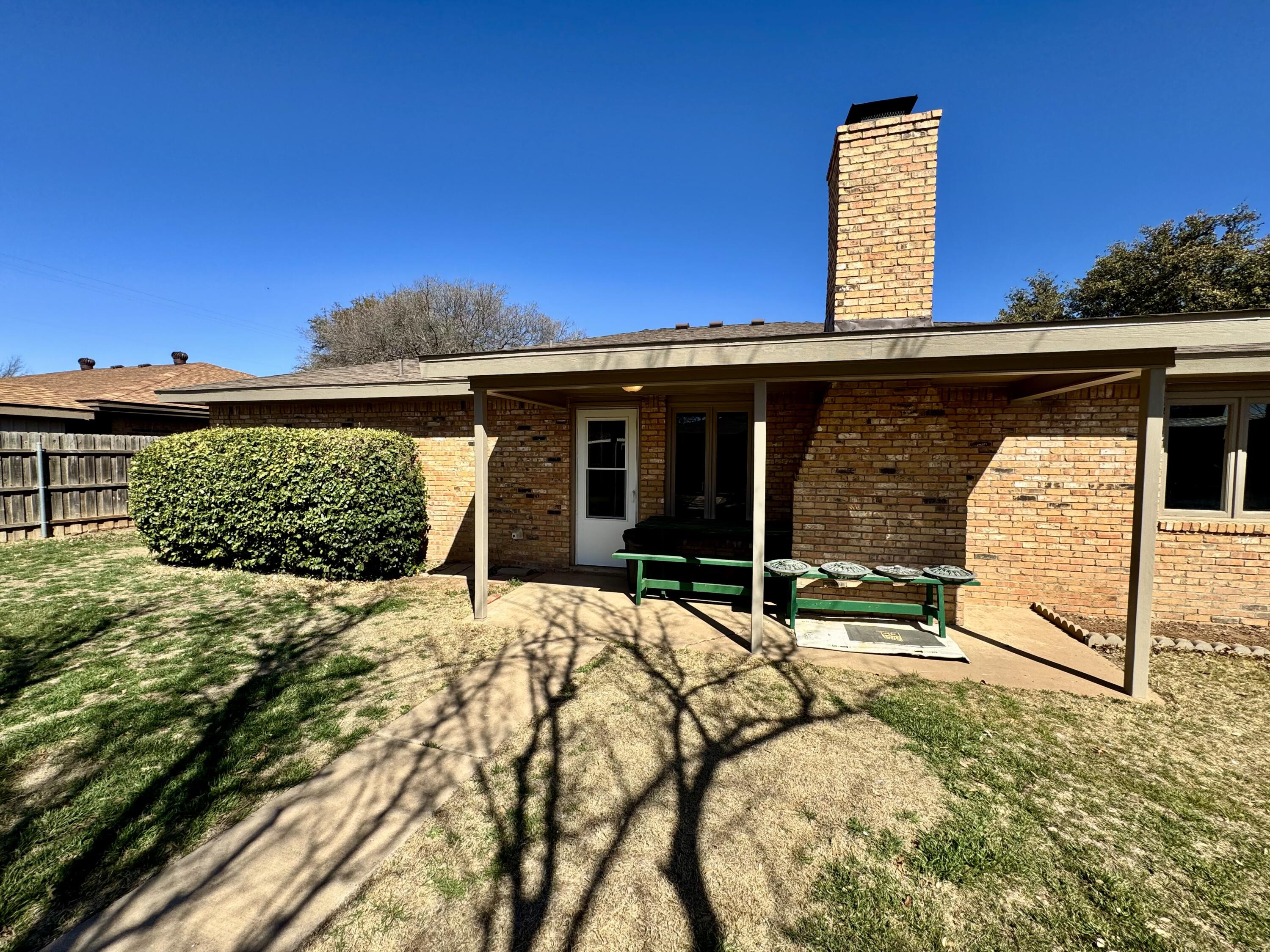 5421 94th Street Lubbock, TX 79424 - Photo 22 of 22 a view of a backyard with a barbeque grill and plants