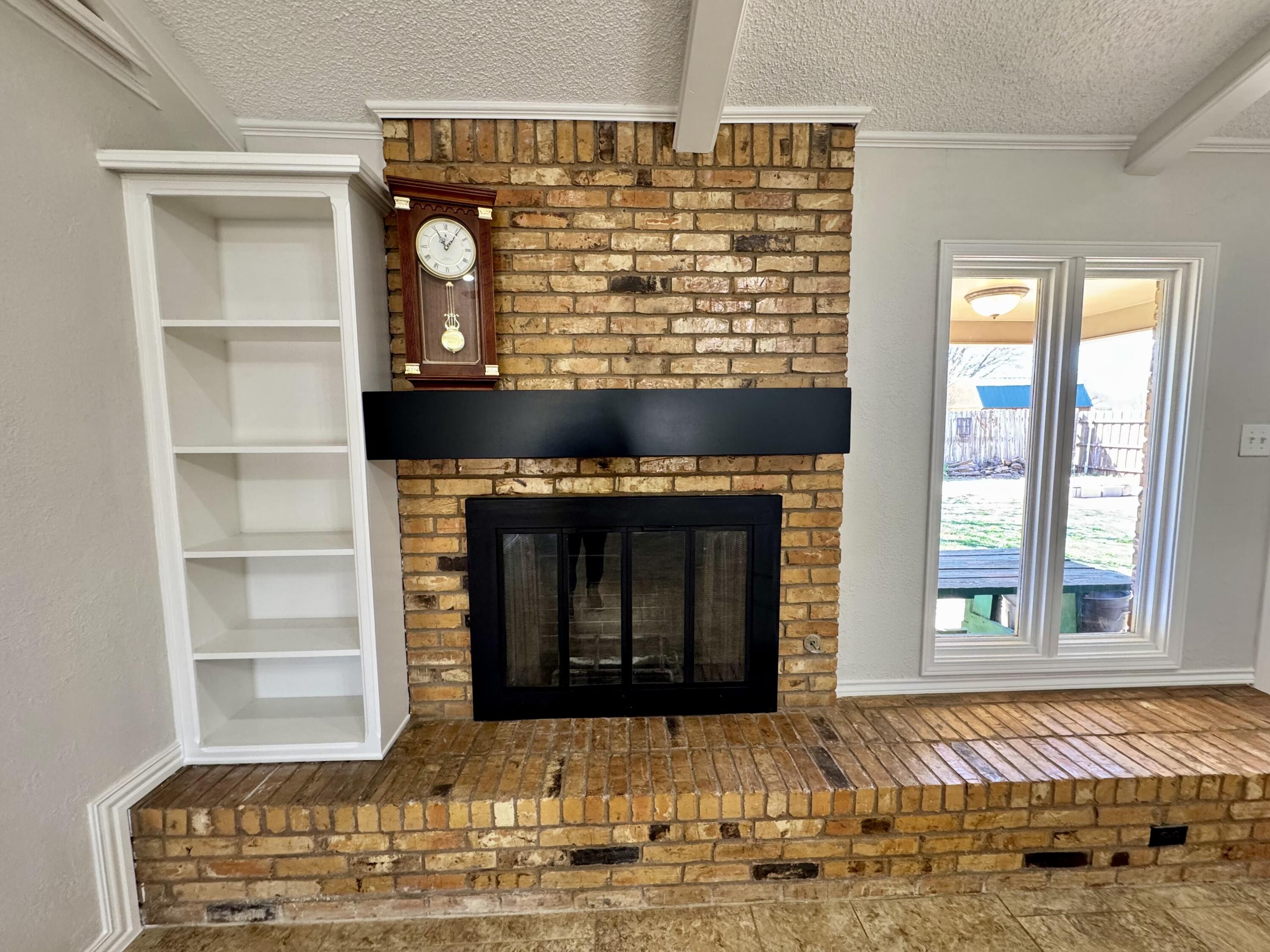 5421 94th Street Lubbock, TX 79424 - Photo 4 of 22 a view of living room with a fireplace and a window