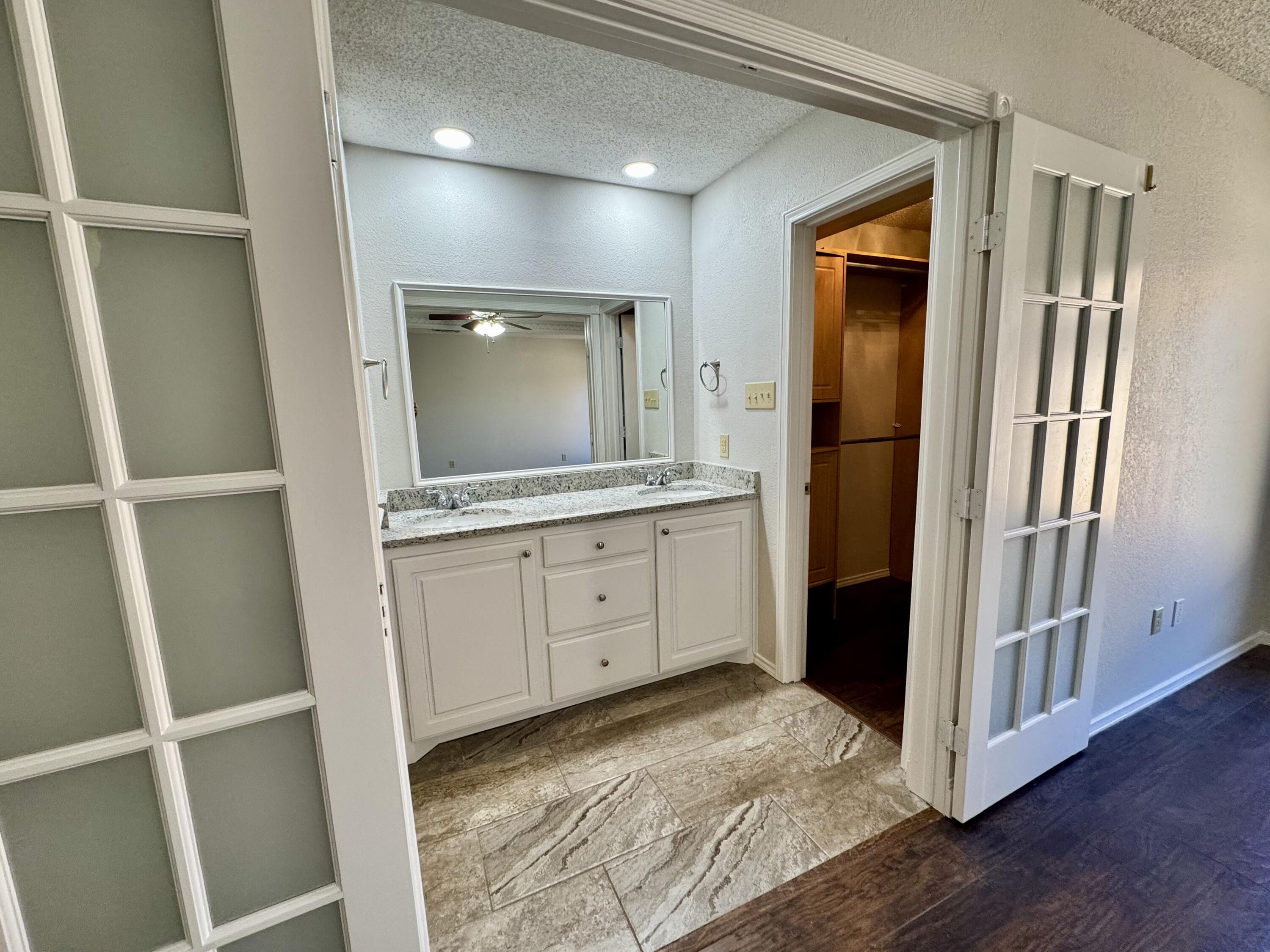 5421 94th Street Lubbock, TX 79424 - Photo 9 of 22 a bathroom with a sink and a mirror