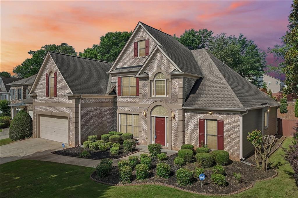 810 Freedom Way Cumming, GA 30040 - Photo 4 of 61 a front view of a house with a yard