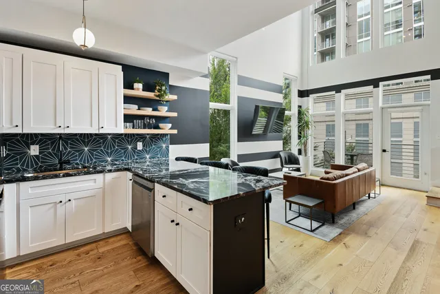 a kitchen with stainless steel appliances granite countertop a stove and cabinets