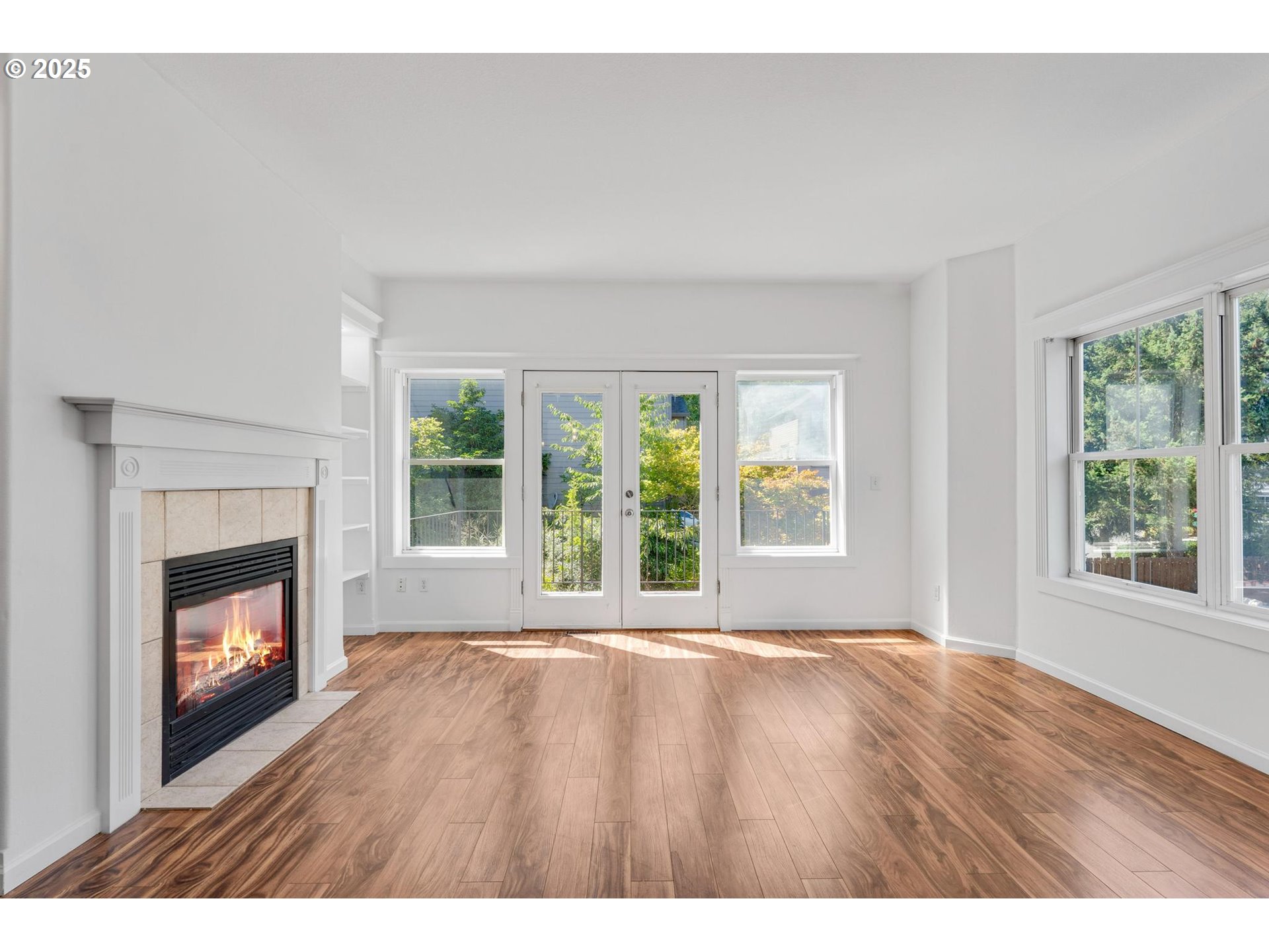 4815 Southwest 1st Avenue Portland, OR 97239 - Photo 15 of 43 a view of an empty room with wooden floor fireplace and a window