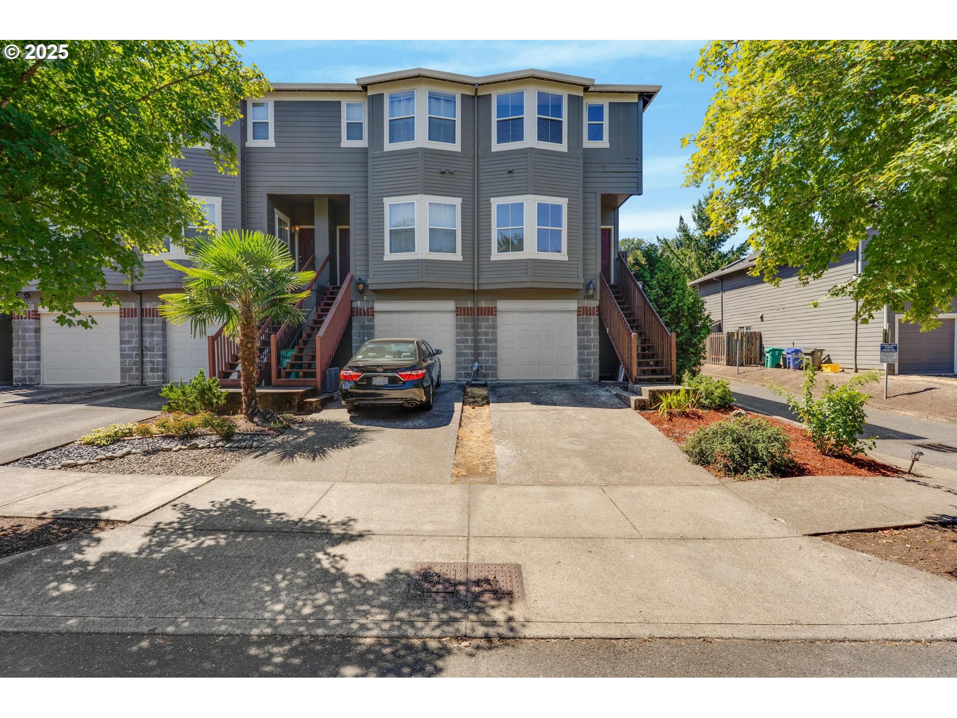4815 Southwest 1st Avenue Portland, OR 97239 - Photo 2 of 43 a view of a brick house with many windows plants and large tree