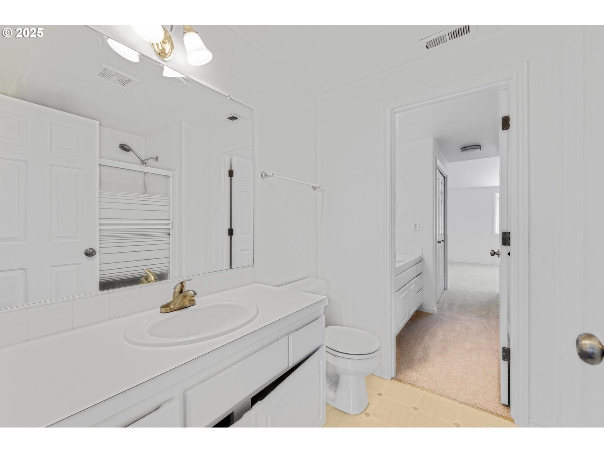 4815 Southwest 1st Avenue Portland, OR 97239 - Photo 23 of 43 a bathroom with a sink toilet a mirror and shower