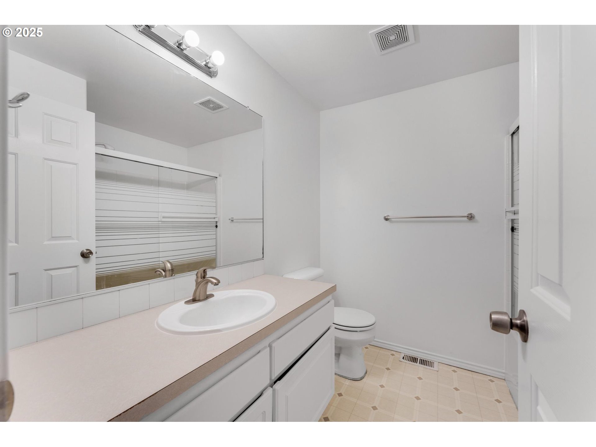 4815 Southwest 1st Avenue Portland, OR 97239 - Photo 27 of 43 a bathroom with a sink toilet and a mirror
