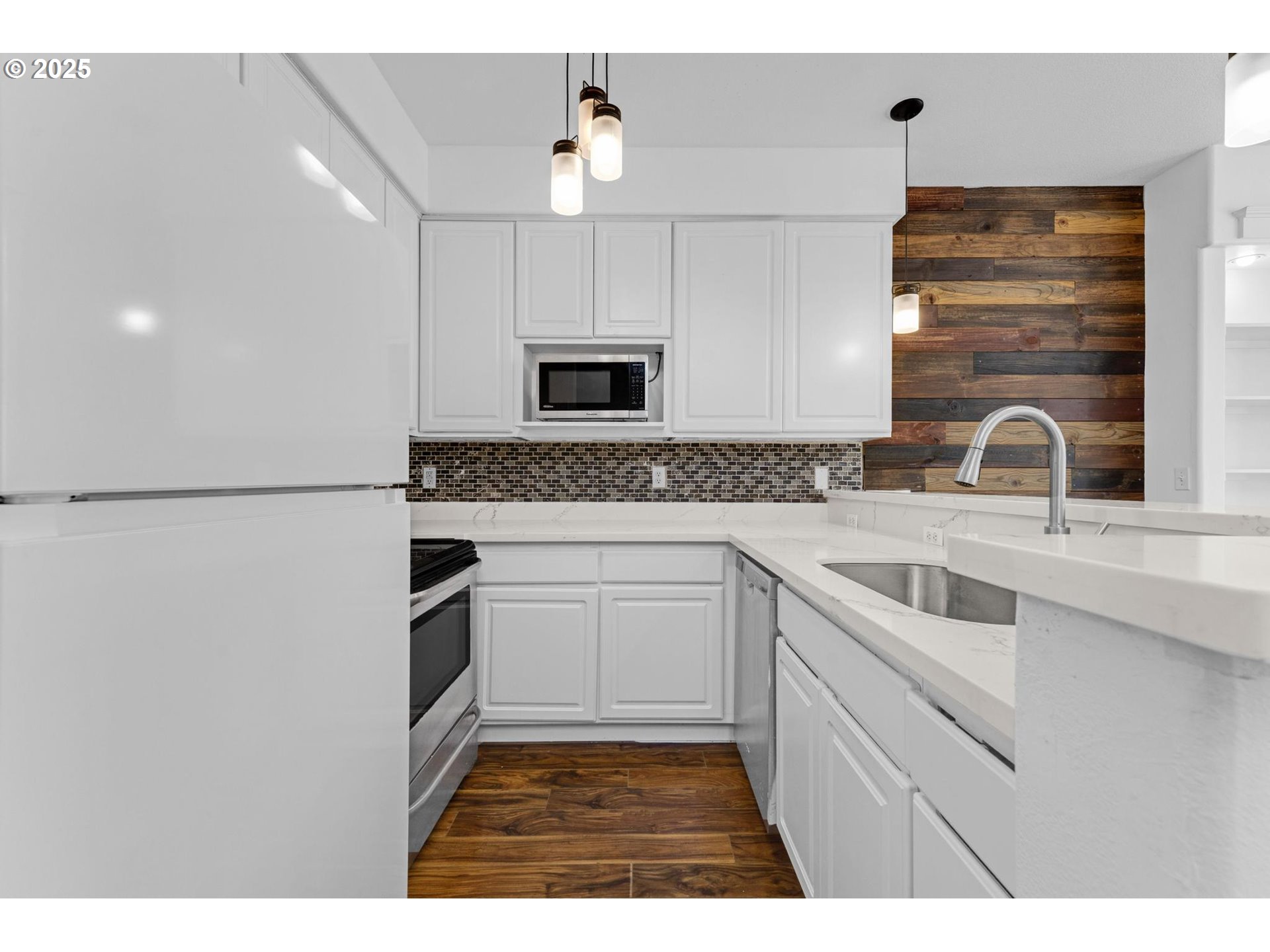 4815 Southwest 1st Avenue Portland, OR 97239 - Photo 6 of 43 a kitchen with a sink cabinets and stainless steel appliances