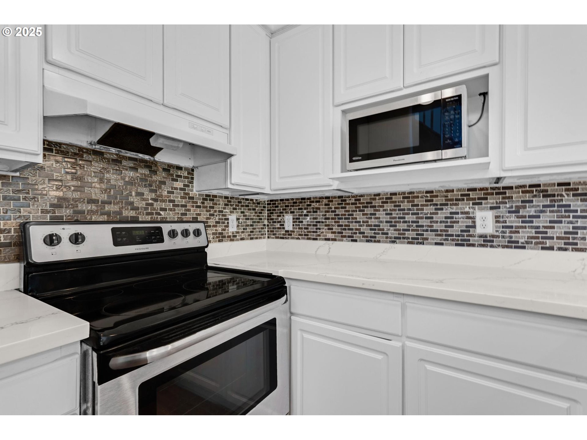4815 Southwest 1st Avenue Portland, OR 97239 - Photo 7 of 43 a kitchen with a stove and a microwave