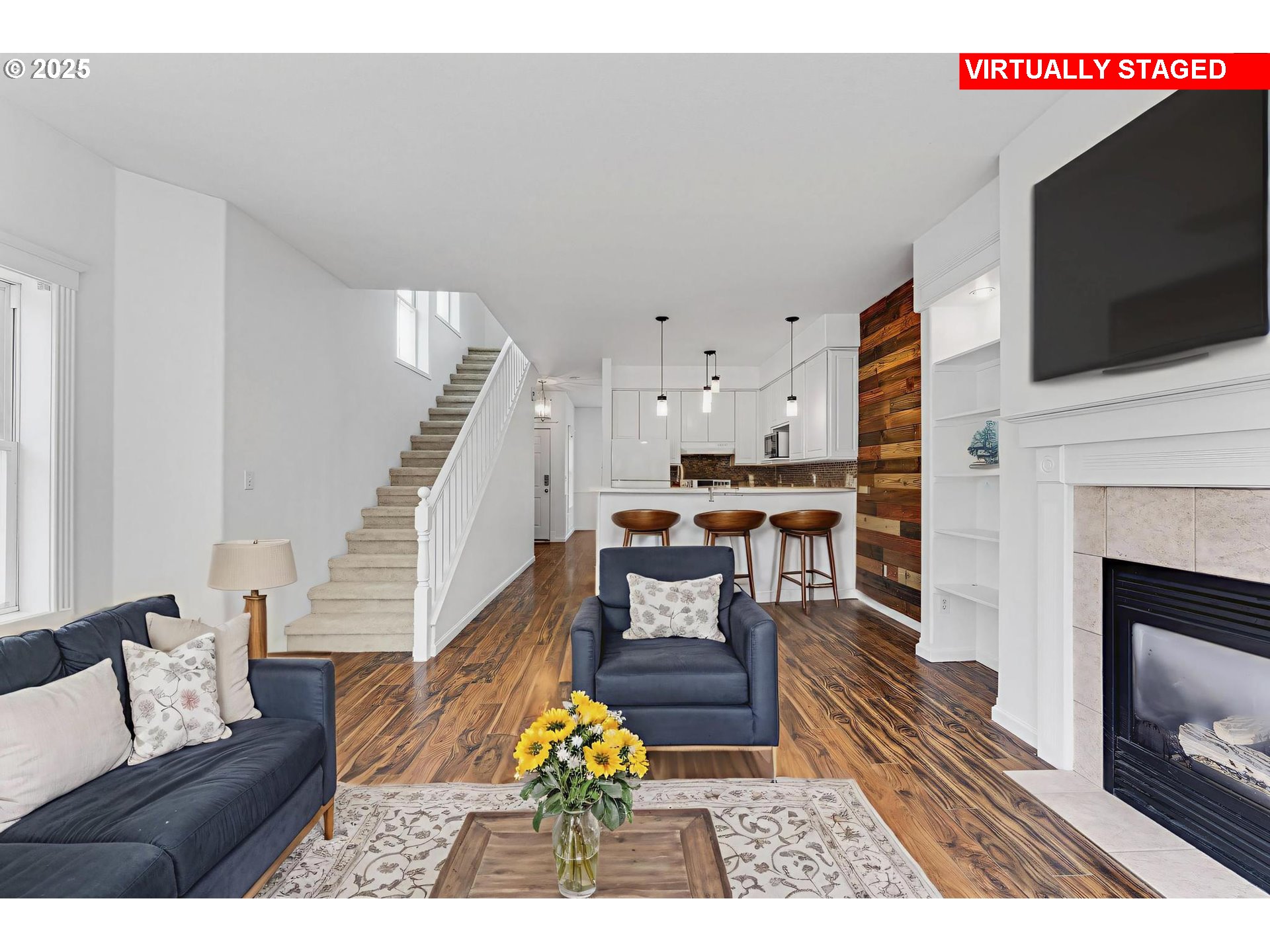 4815 Southwest 1st Avenue Portland, OR 97239 - Photo 8 of 43 a living room with furniture a flat screen tv and a fireplace