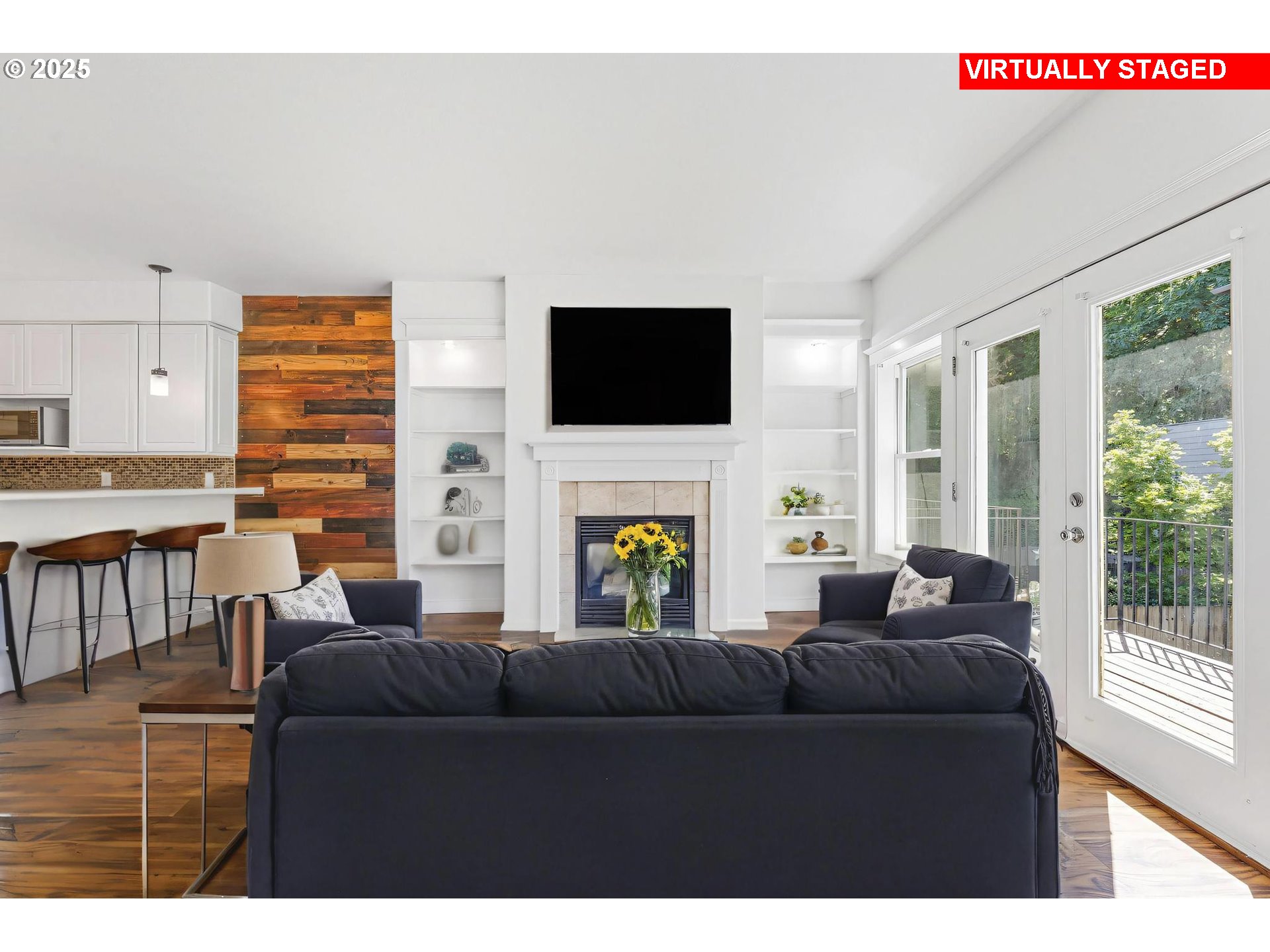 4815 Southwest 1st Avenue Portland, OR 97239 - Photo 9 of 43 a living room with furniture a fireplace and a flat screen tv