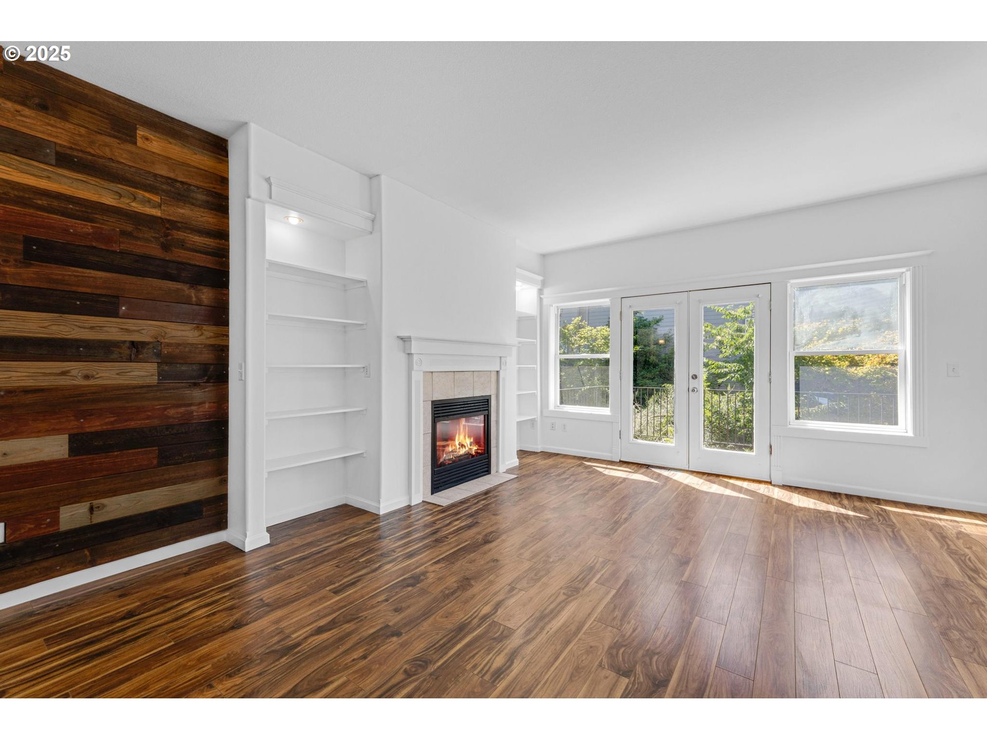 4815 Southwest 1st Avenue Portland, OR 97239 - Photo 10 of 43 a view of an empty room with wooden floor fireplace and a window