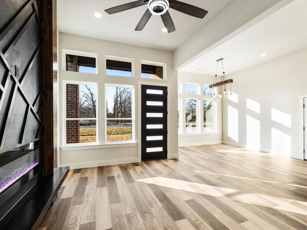 5018 Point La Vista Road Malakoff, TX 75148 - Photo 9 of 32 Foyer entrance featuring light wood-type flooring, a ceiling fan, hanging lights, and a high ceiling