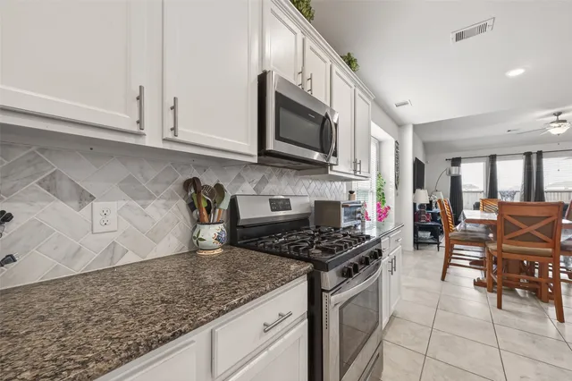 a kitchen with stainless steel appliances granite countertop a stove and a sink