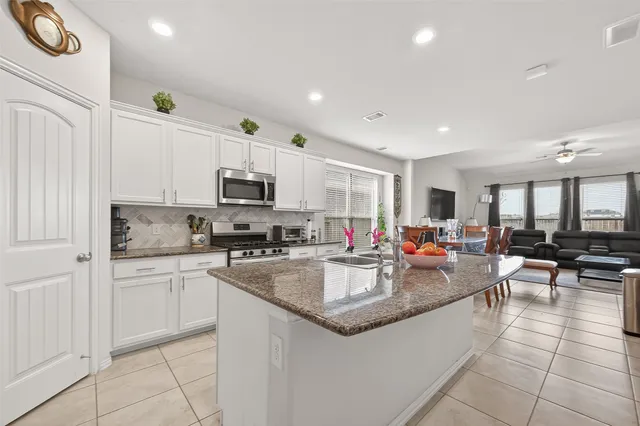a large kitchen with lots of counter space and a sink