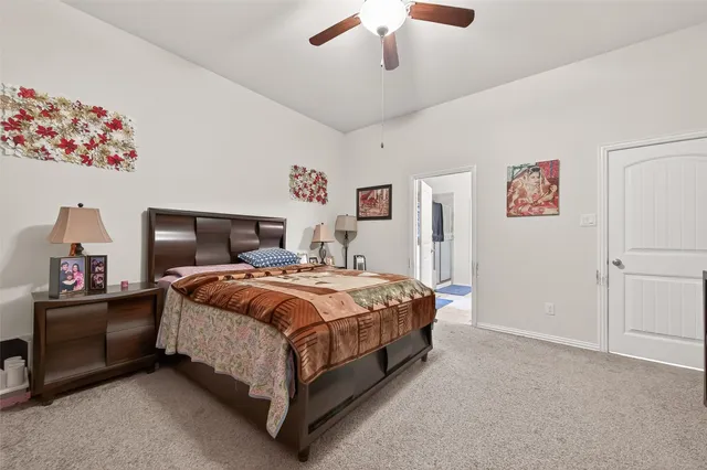 a spacious bedroom with a bed and a chandelier