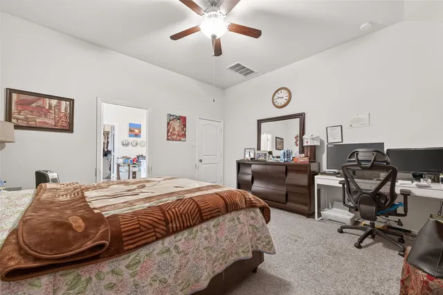 a bedroom with a bed a desk and chair