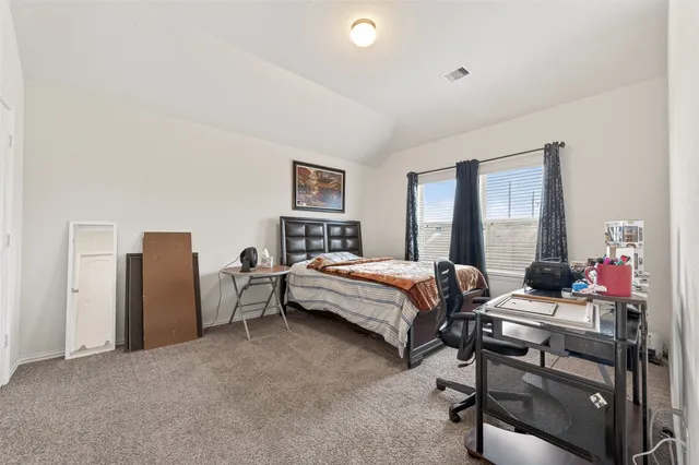 a bedroom with a bed and a table