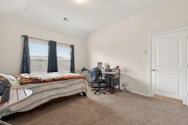 a bedroom with bed and a window