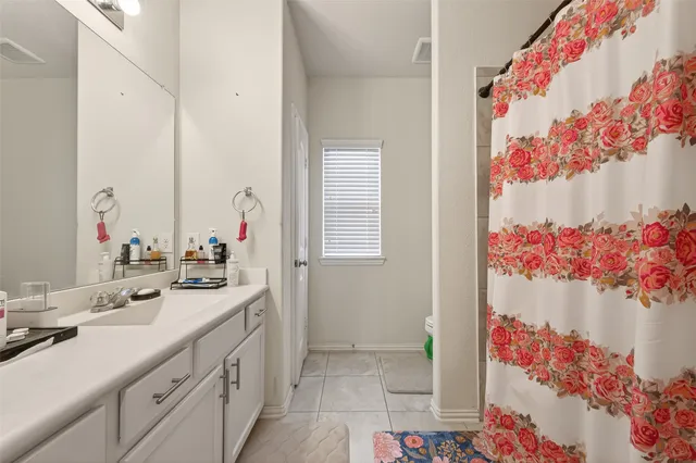 a bathroom with a sink mirror and vanity