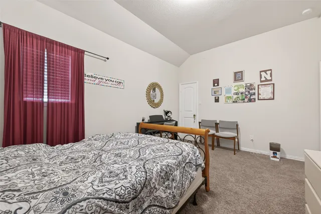 a bedroom with a bed and a dresser in it