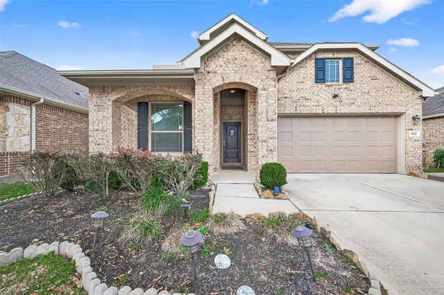 a view of a brick house with large windows