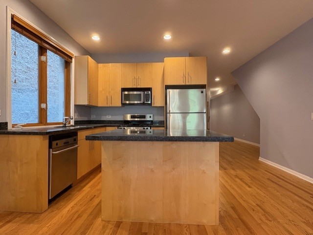 1543 North Hudson Avenue, Unit 2 Chicago, IL 60610 - Photo 4 of 19 a kitchen with stainless steel appliances a refrigerator a stove a sink and a microwave