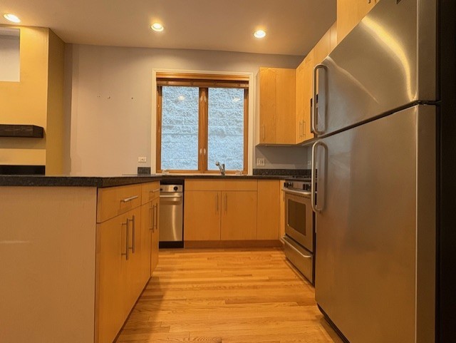 1543 North Hudson Avenue, Unit 2 Chicago, IL 60610 - Photo 5 of 19 a view of a kitchen with wooden floor and a window