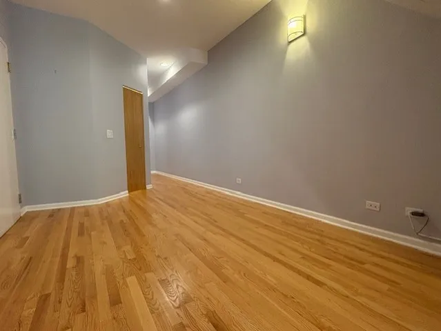 a view of an empty room and wooden floor