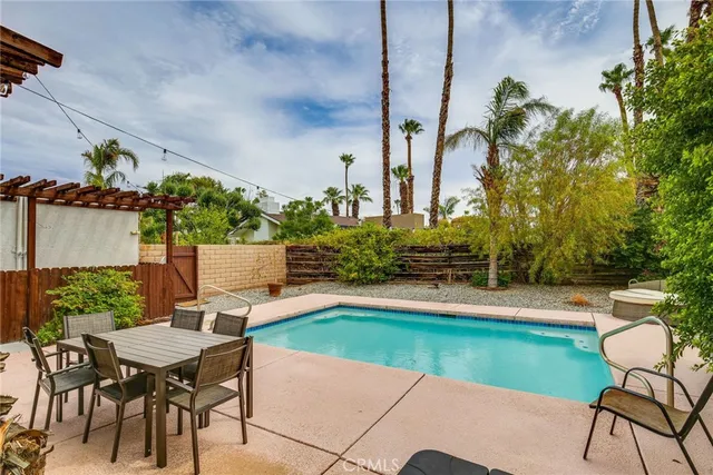 a view of a patio with table and chairs under an umbrella