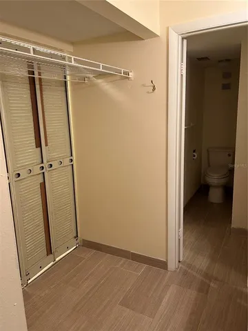 a white toilet sitting next to a bath tub