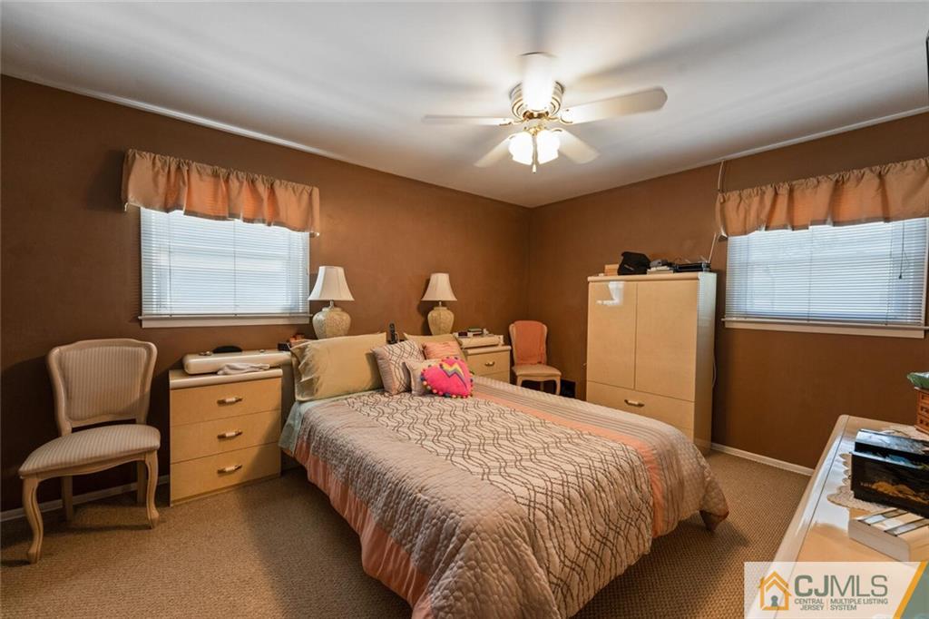 10 Monaghan Road Edison, NJ 08817 - Photo 17 of 23 a bed room with a bed and a chair