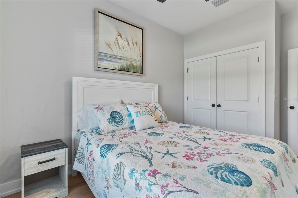 9155 Agate Street Port Charlotte, FL 33981 - Photo 14 of 30 a bedroom with a bed and a painting on the wall