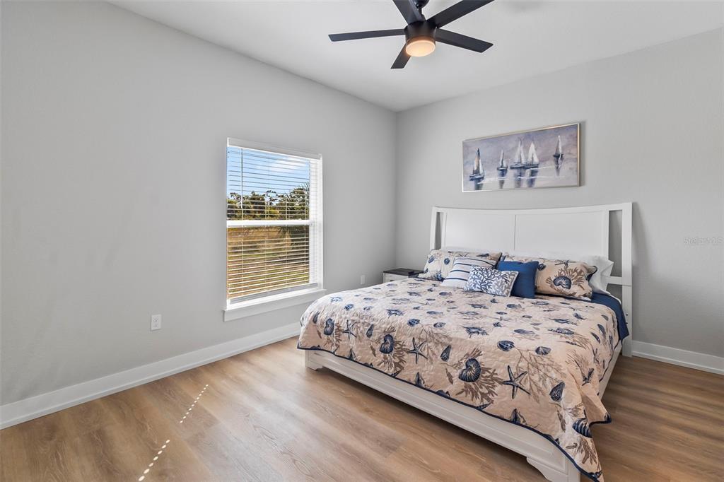 9155 Agate Street Port Charlotte, FL 33981 - Photo 18 of 30 a bedroom with a large bed and a window