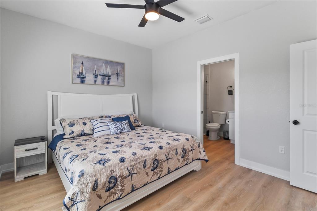 9155 Agate Street Port Charlotte, FL 33981 - Photo 19 of 30 a bedroom with a bed and wooden floor