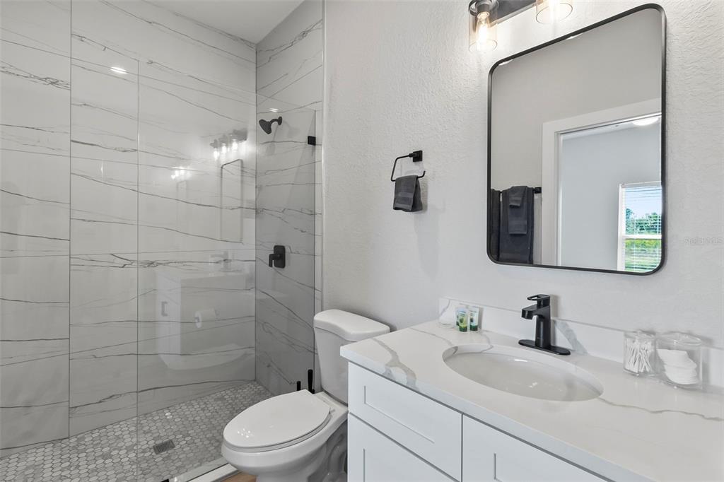 9155 Agate Street Port Charlotte, FL 33981 - Photo 21 of 30 a bathroom with a sink a toilet and shower