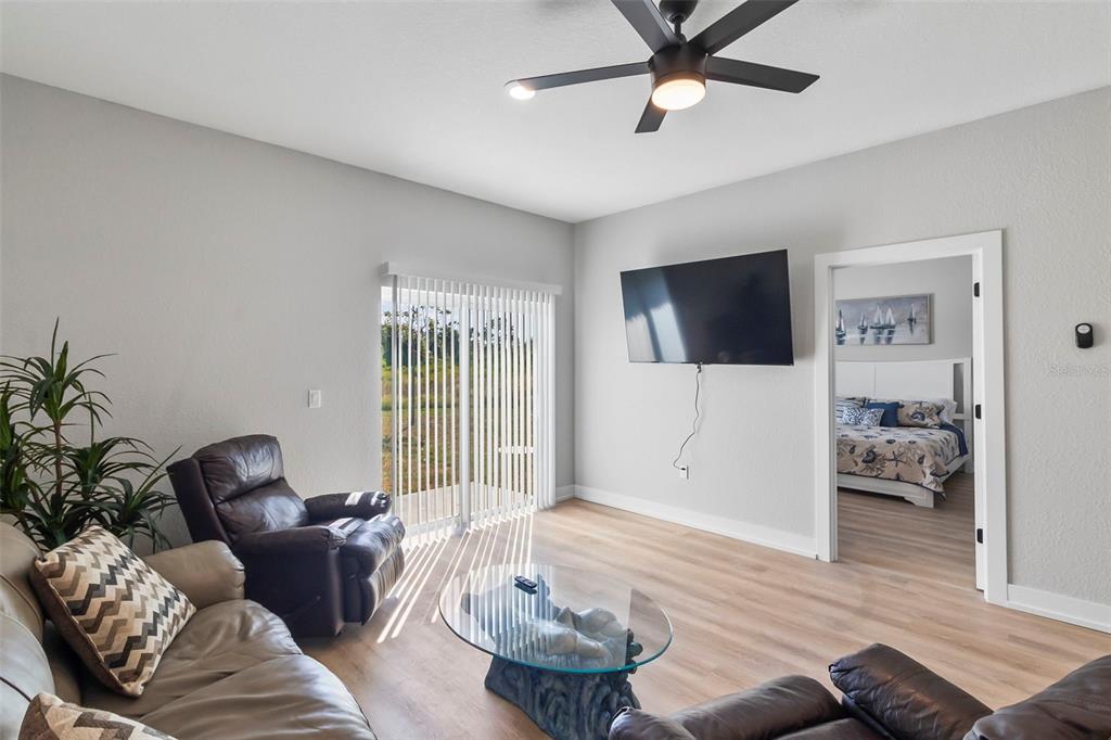 9155 Agate Street Port Charlotte, FL 33981 - Photo 27 of 30 a living room with furniture and a flat screen tv