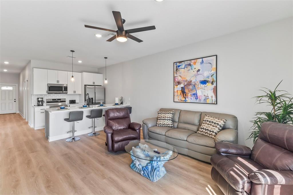 9155 Agate Street Port Charlotte, FL 33981 - Photo 28 of 30 a living room with furniture kitchen view and a potted plant