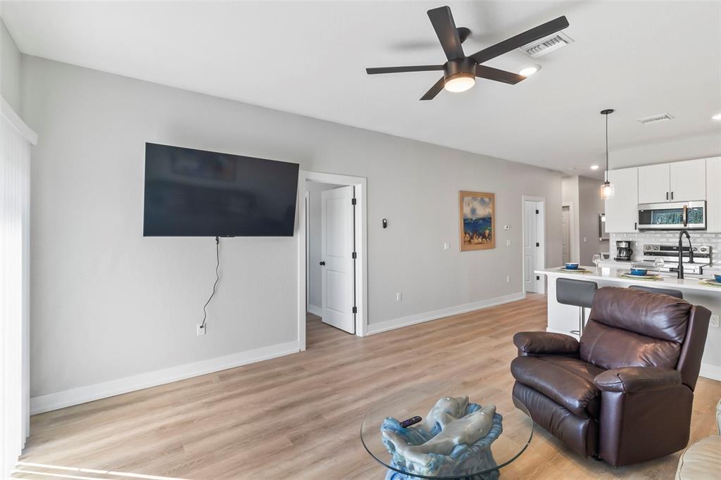 9155 Agate Street Port Charlotte, FL 33981 - Photo 29 of 30 a living room with furniture and a flat screen tv