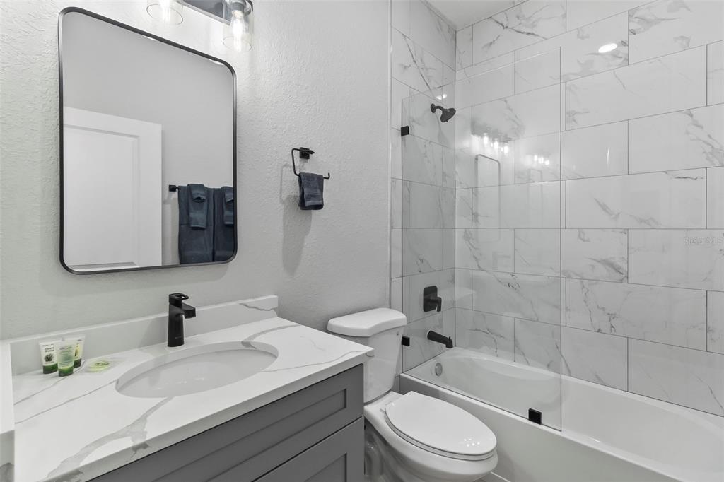 9155 Agate Street Port Charlotte, FL 33981 - Photo 5 of 30 a bathroom with a sink a toilet and a mirror