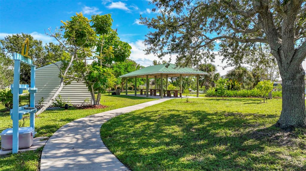 9155 Agate Street Port Charlotte, FL 33981 - Photo 10 of 30 a view of a swimming pool with a garden