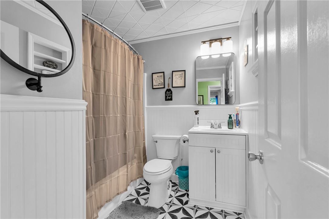 1305 Hanover Road Anderson, SC 29621 - Photo 14 of 29 Classic beadboard paneling and patterned floor tile bring timeless character to this bathroom.