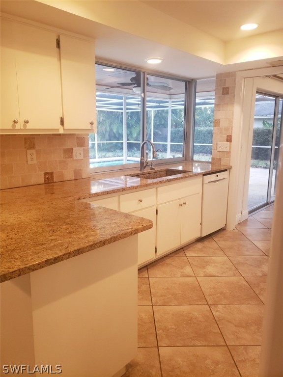 5692 Eichen Circle Fort Myers, FL 33919 - Photo 11 of 33 a large kitchen with kitchen island granite countertop a large window