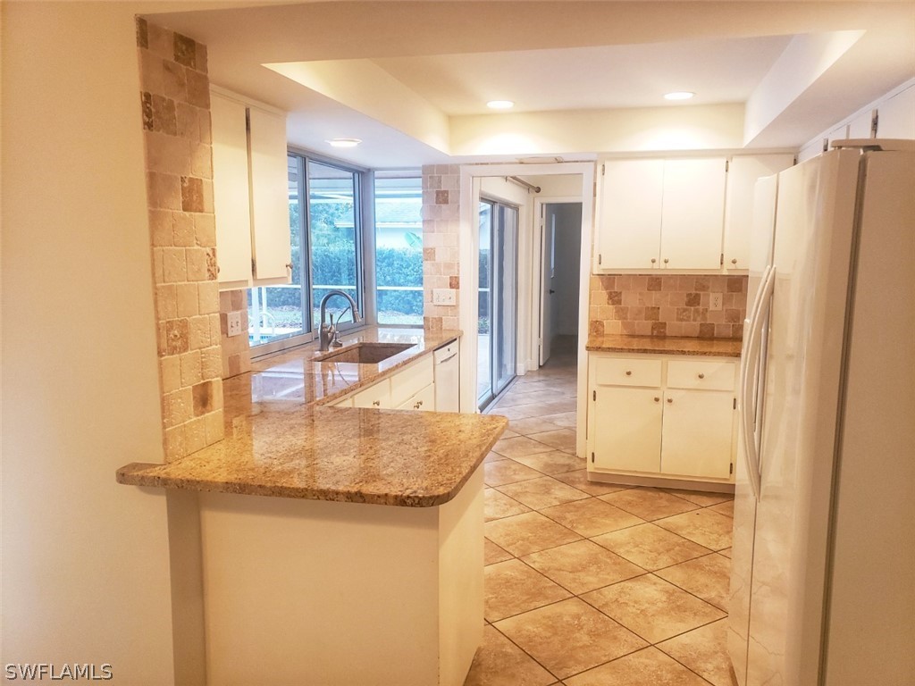 5692 Eichen Circle Fort Myers, FL 33919 - Photo 13 of 33 a bathroom with a granite countertop sink a mirror and a shower