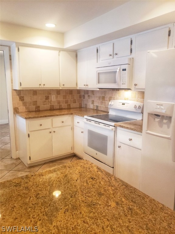 5692 Eichen Circle Fort Myers, FL 33919 - Photo 14 of 33 a kitchen with white cabinets appliances and a sink