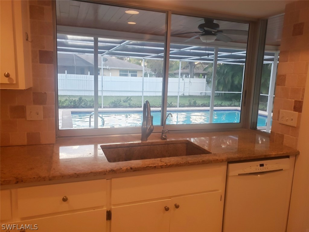 5692 Eichen Circle Fort Myers, FL 33919 - Photo 16 of 33 a kitchen with granite countertop a sink and a window