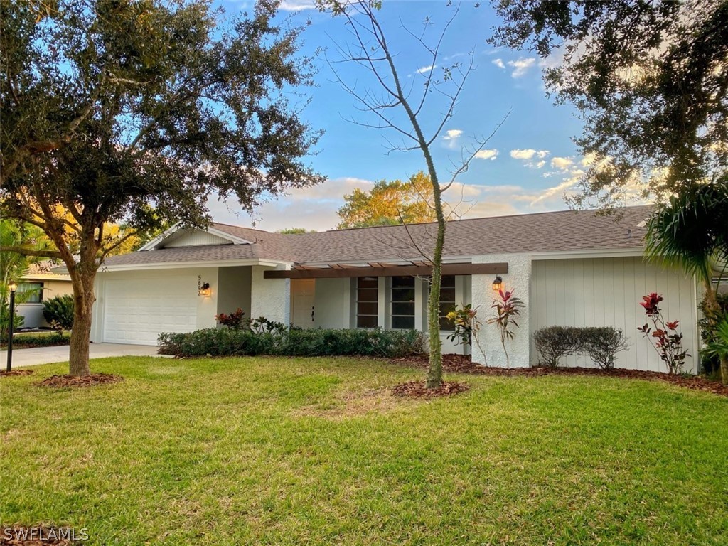 5692 Eichen Circle Fort Myers, FL 33919 - Photo 3 of 33 a backyard of a house with yard and outdoor seating