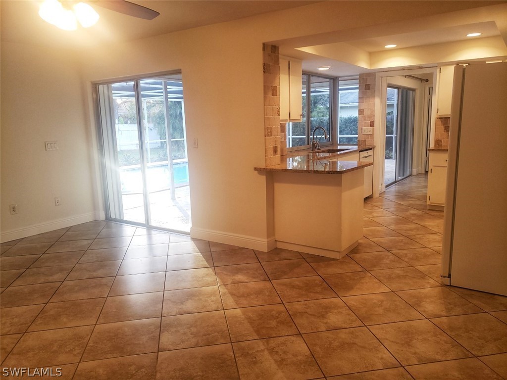 5692 Eichen Circle Fort Myers, FL 33919 - Photo 10 of 33 a view of a refrigerator in kitchen and an empty room