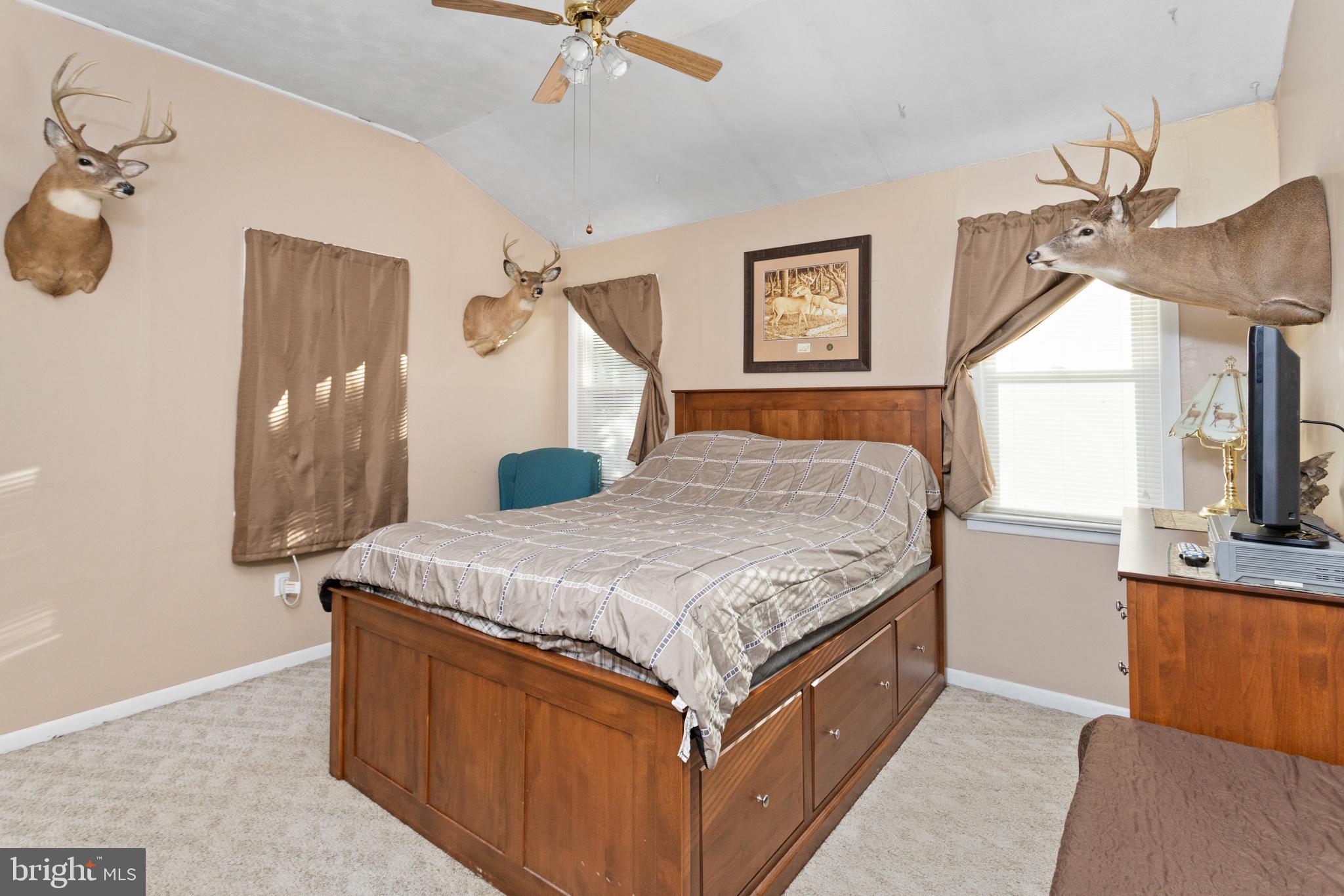 450 Stokes Road Shamong, NJ 08088 - Photo 15 of 35 a bedroom with a bed and a chandelier