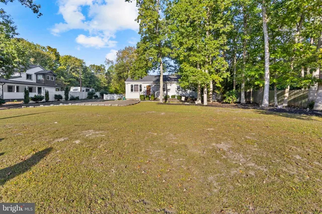 a yellow house with trees in front of it